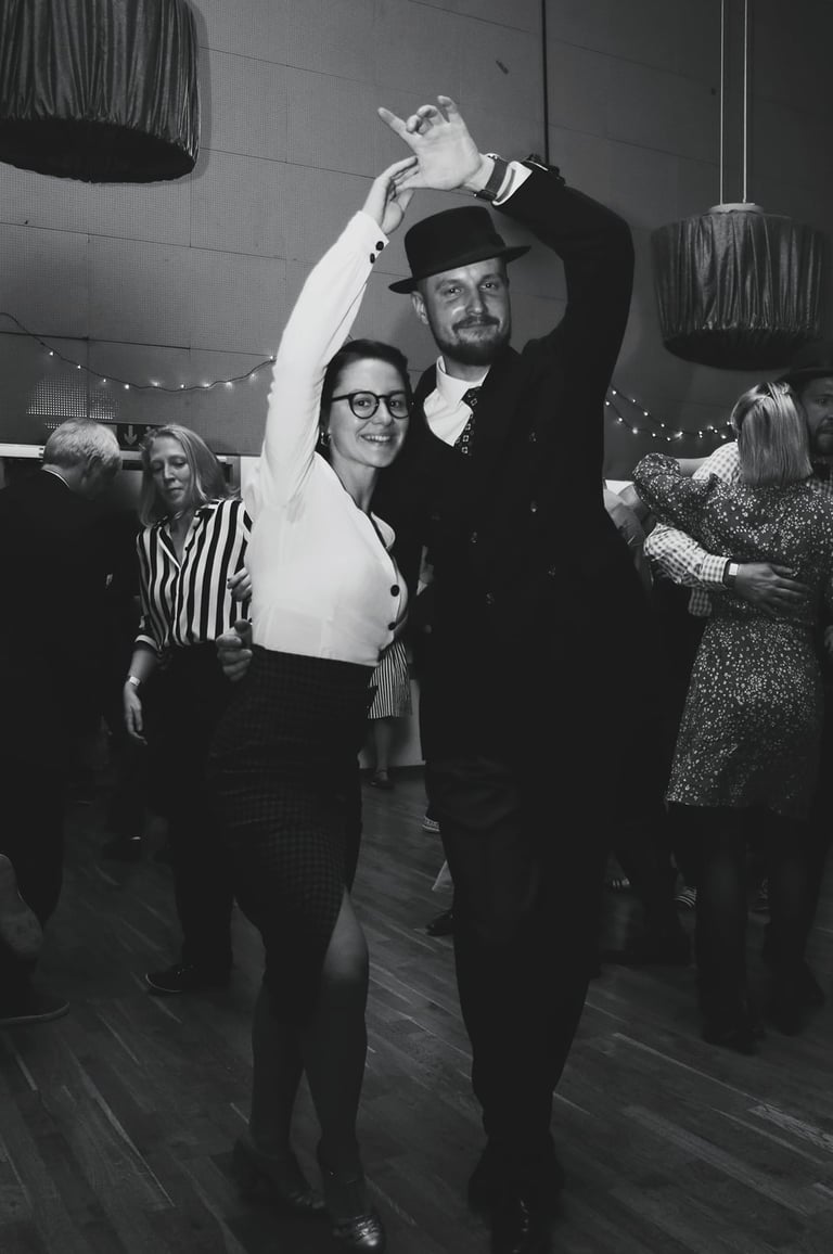 a man and woman dancing at a dance floor