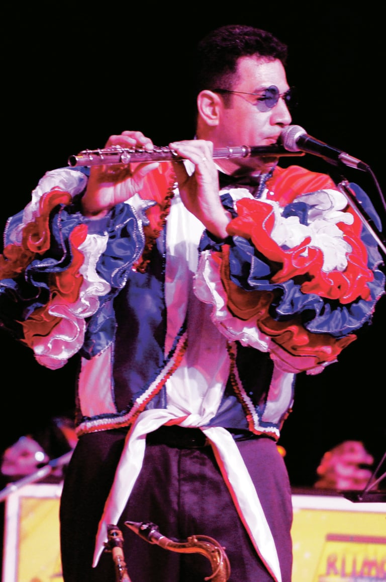Maestro Bobby Ramirez playing flute in cuban style rumba Show attire