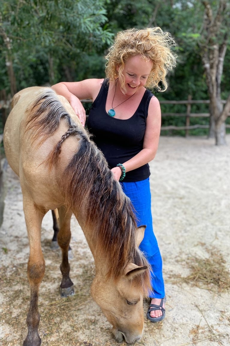 Sunni Dawson with a horse in a rural setting—reflecting intuitive connection