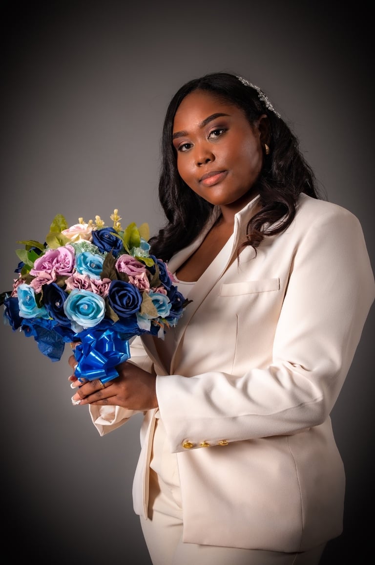 a woman in a white suit and a bouquet of flowers