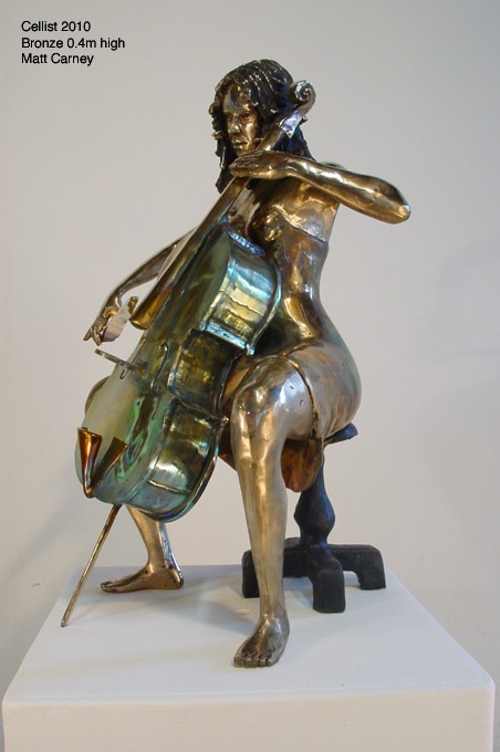 a statue of a woman playing the cello