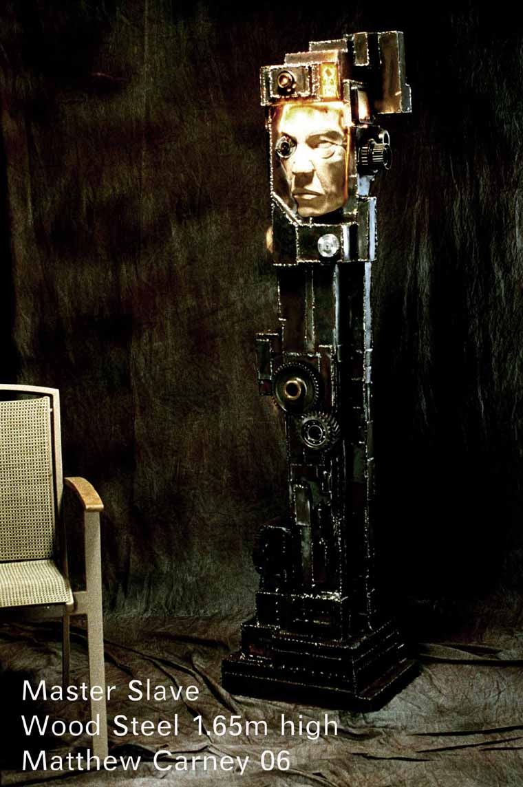 a sculpture of a mans wooden face trapped inside a steel armature with circuit boards and lights