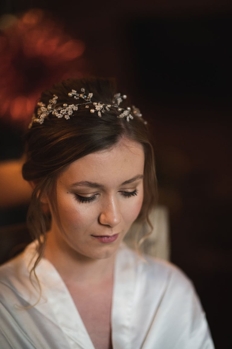 a woman in wedding makeup and a white robe