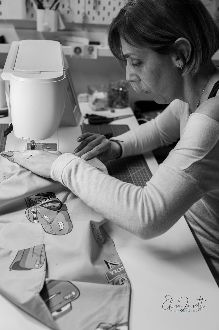 a woman is sewing an accessory on a sewing machine