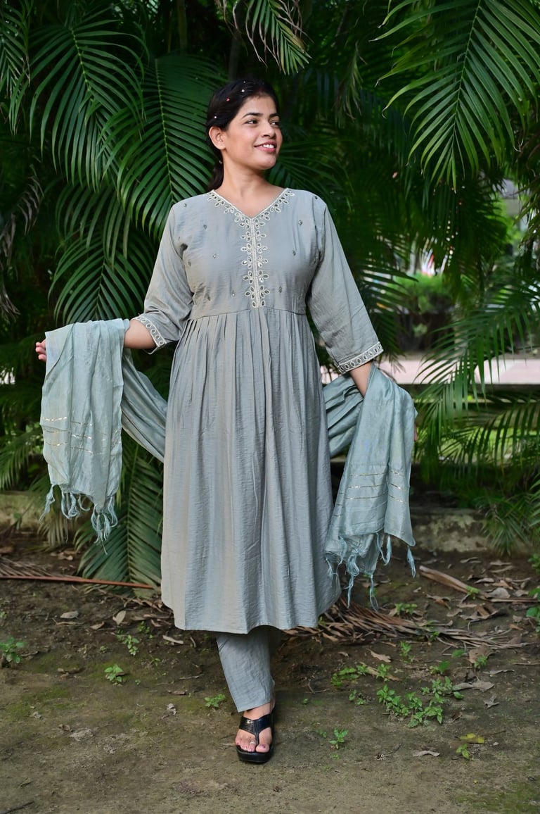 front-view of suit wearing women with trees in background