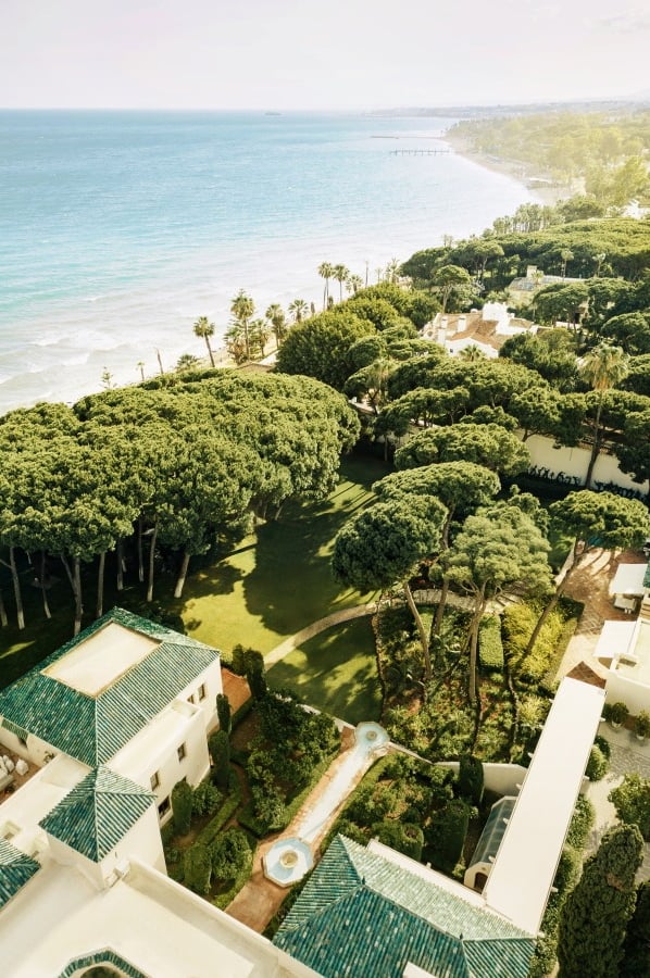 Aerial view of Villa El Rincon, luxury beachfront villa in Marbella with private pool, lush gardens, and panoramic sea views.