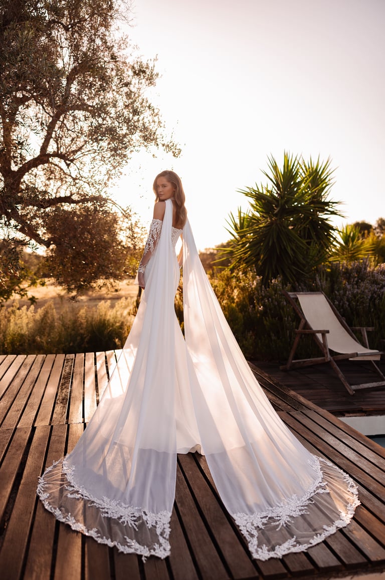 a woman in a wedding dress standing on a deck