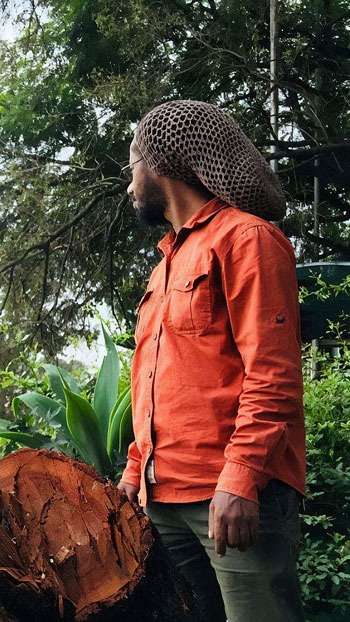 a man in a hat on a tree stump