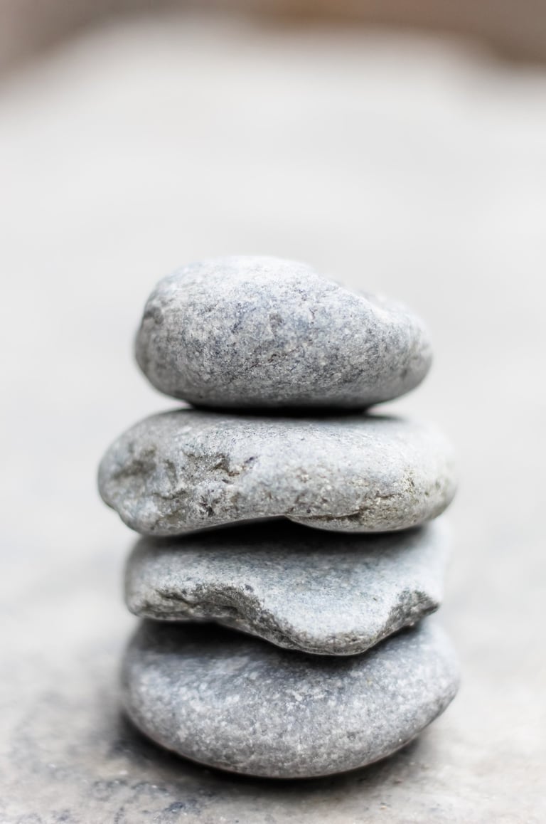a balanced stack of light grey rocks