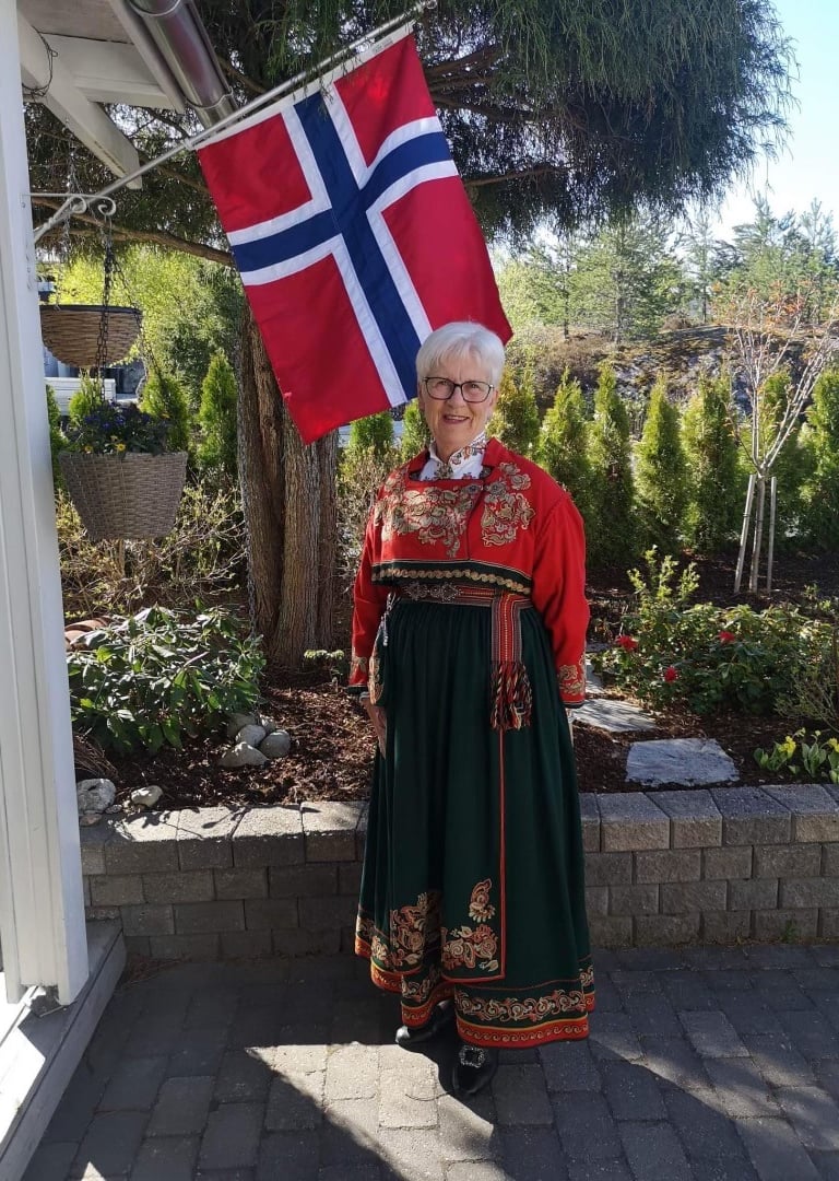 A woman with white hair in a telemark bunad