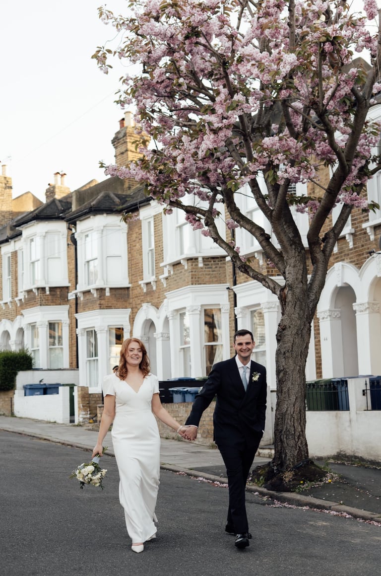 wedding couple walking down the street smiling