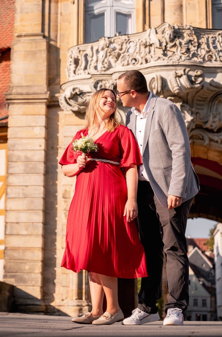 a bride and a groom standing in front of a building
