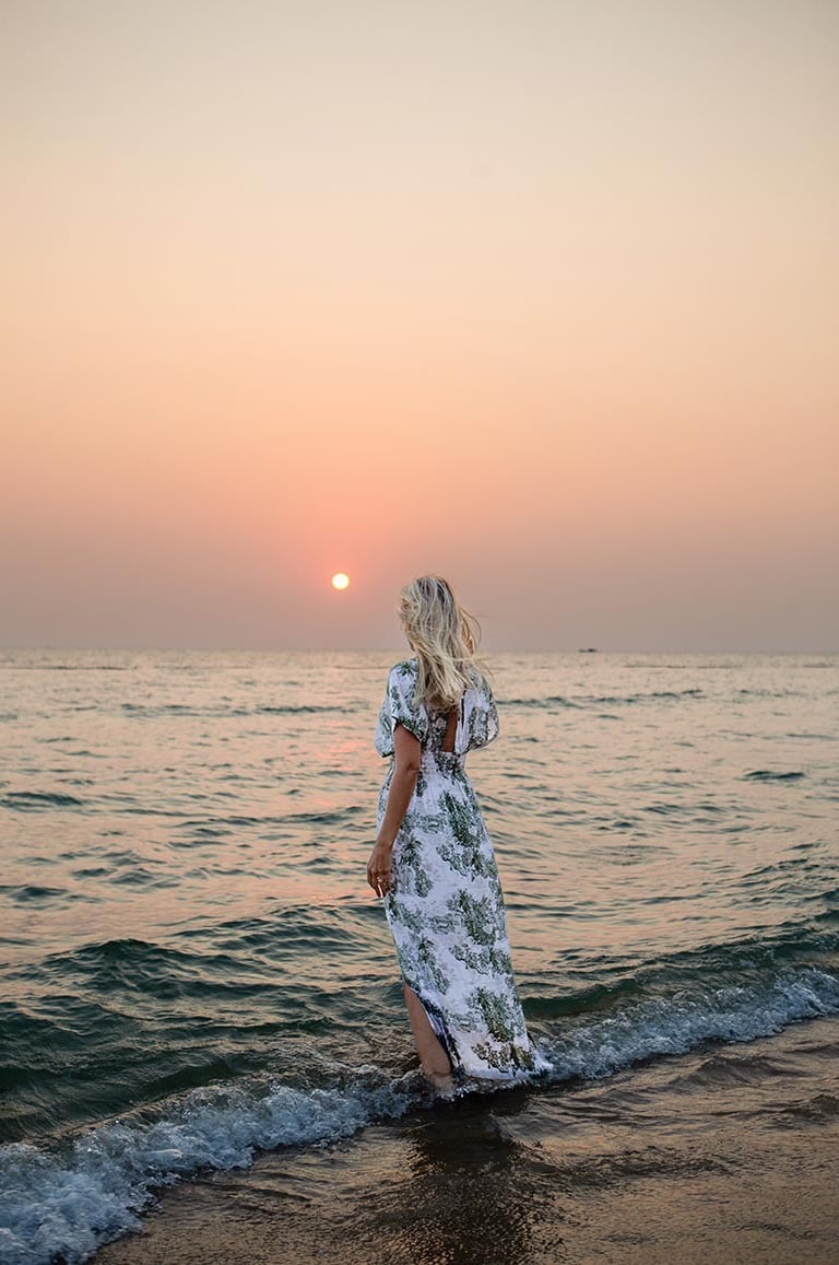 Woman walking in the ocean during a sunset photoshoot in Phu Quoc