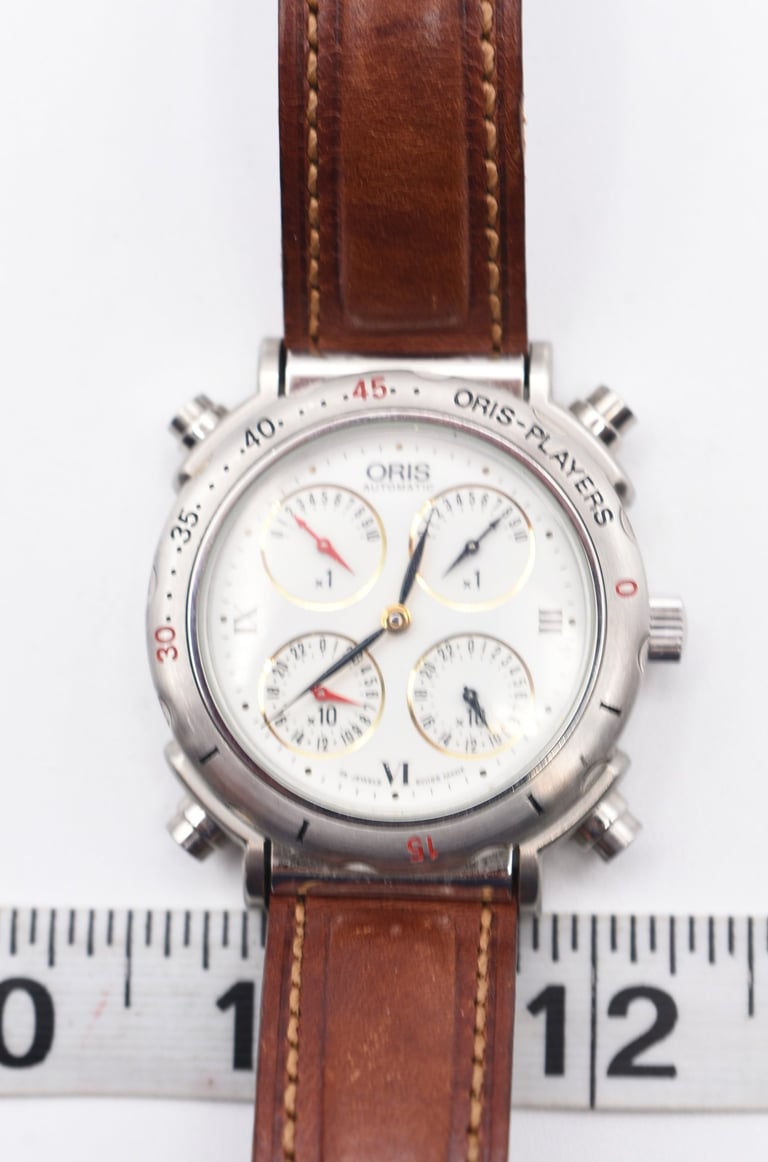 Vintage Oris Players automatic watch with a white chronograph dial and brown leather strap.
