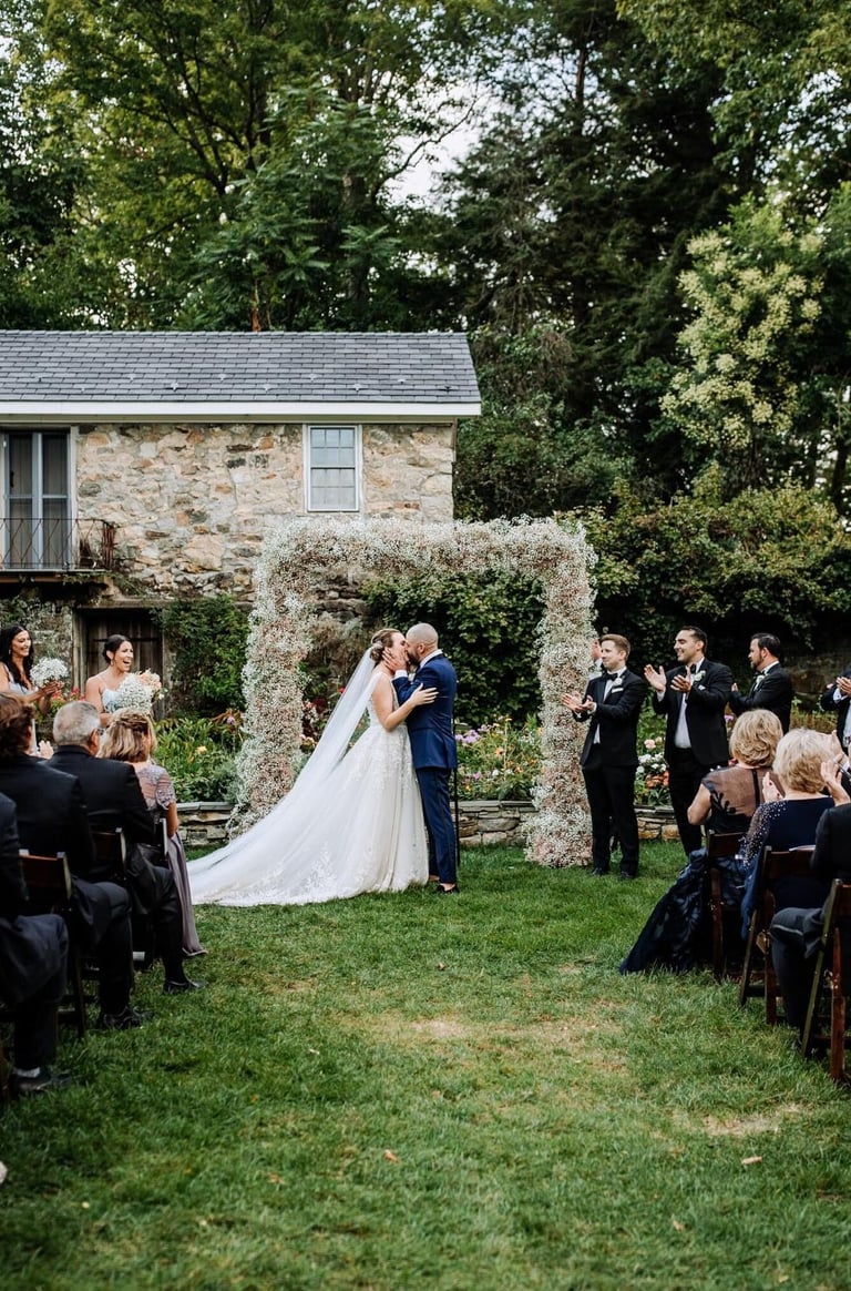 Couple kissing at alter in outdoor field