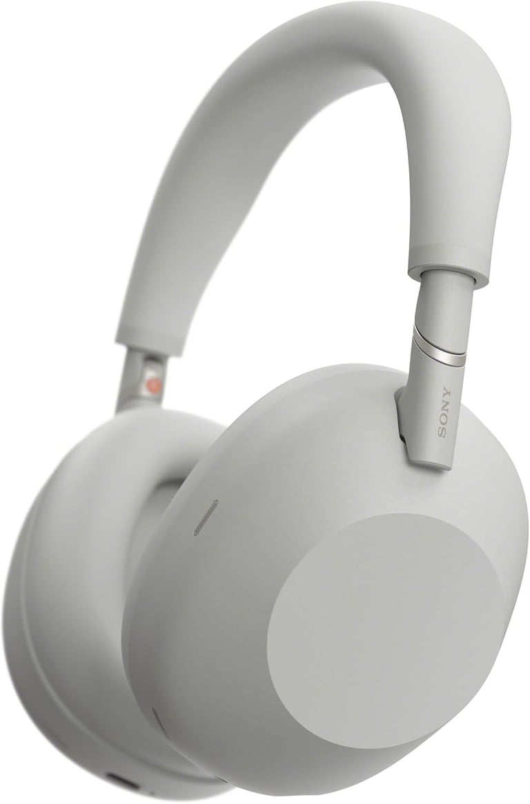 Sony WH-1000XM5 wireless noise-canceling headphones in silver with plush earcups and padded headband.