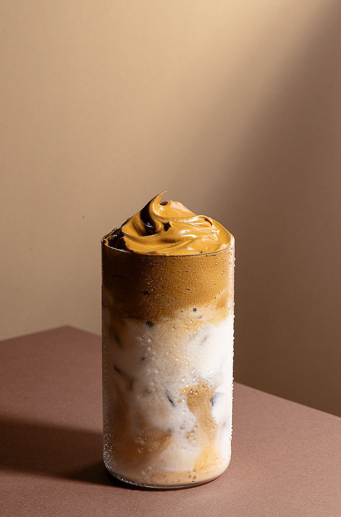 a glass of iced coffee with a cream 