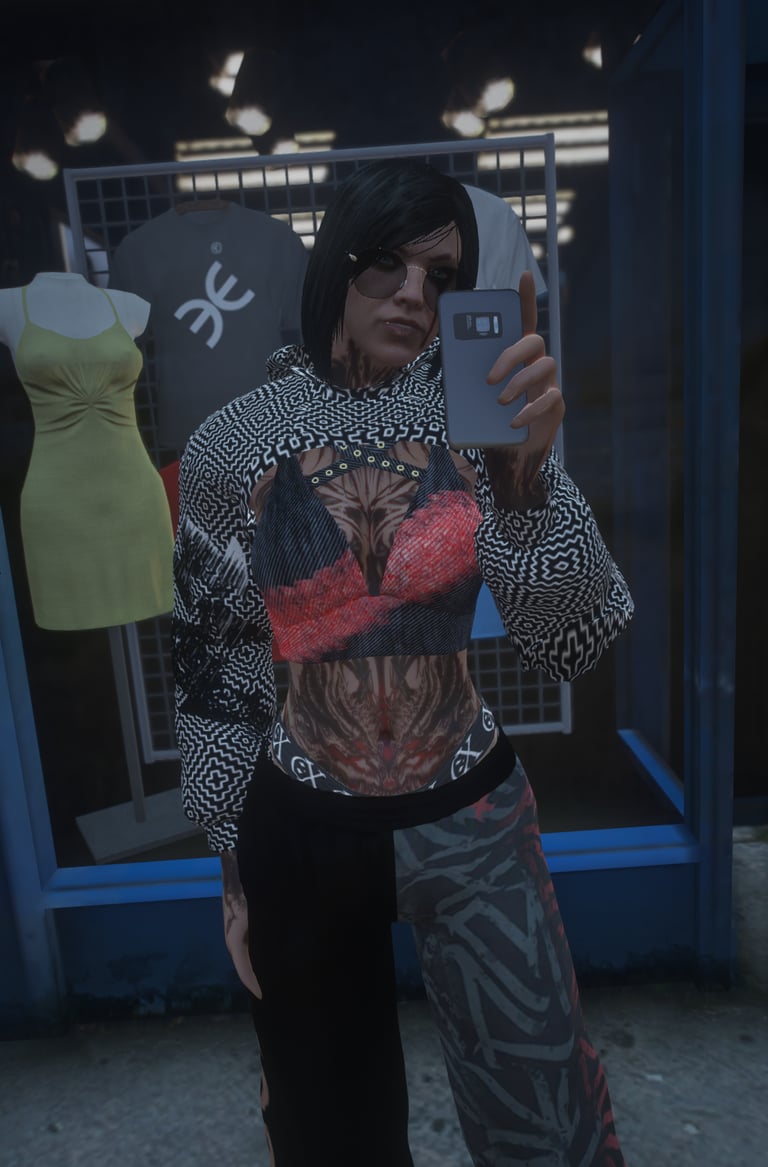 a woman in a top hat and sunglasses taking a selfie