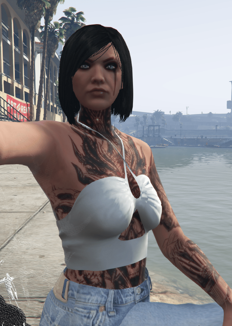 a woman with tattoos on her chest and chest