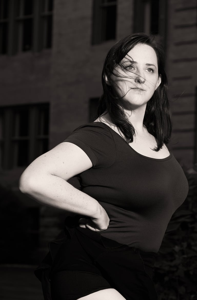 a woman in a black and white photo with a dance pose