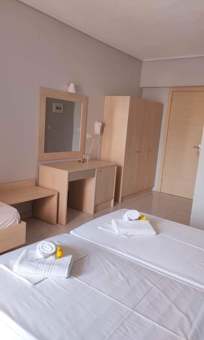 a bedroom with two beds and a desk