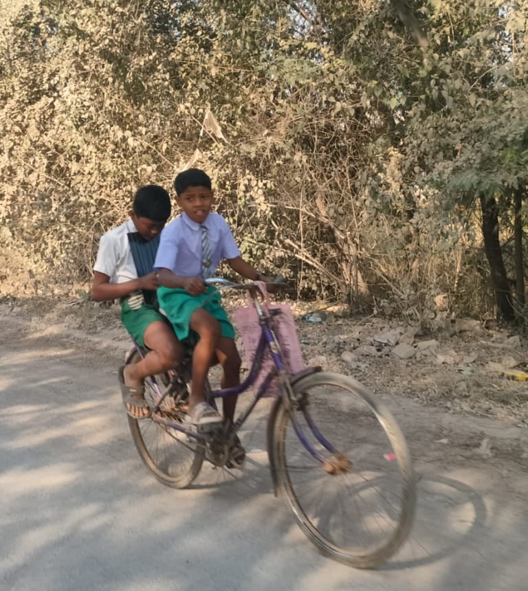 two boys go to school by bicycle