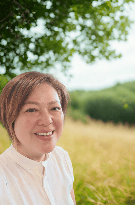 Alix in her element, surrounded by nature, embodies the grounded, nurturing care she offers clients