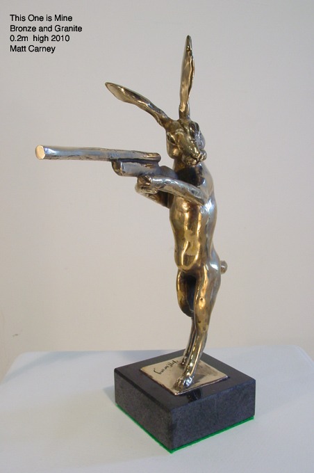 a bronze sculpture of a rabbit with a gun