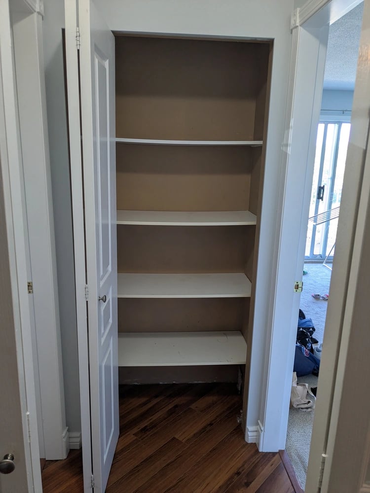 Old kitchenware closet, empty: just sagging shelving