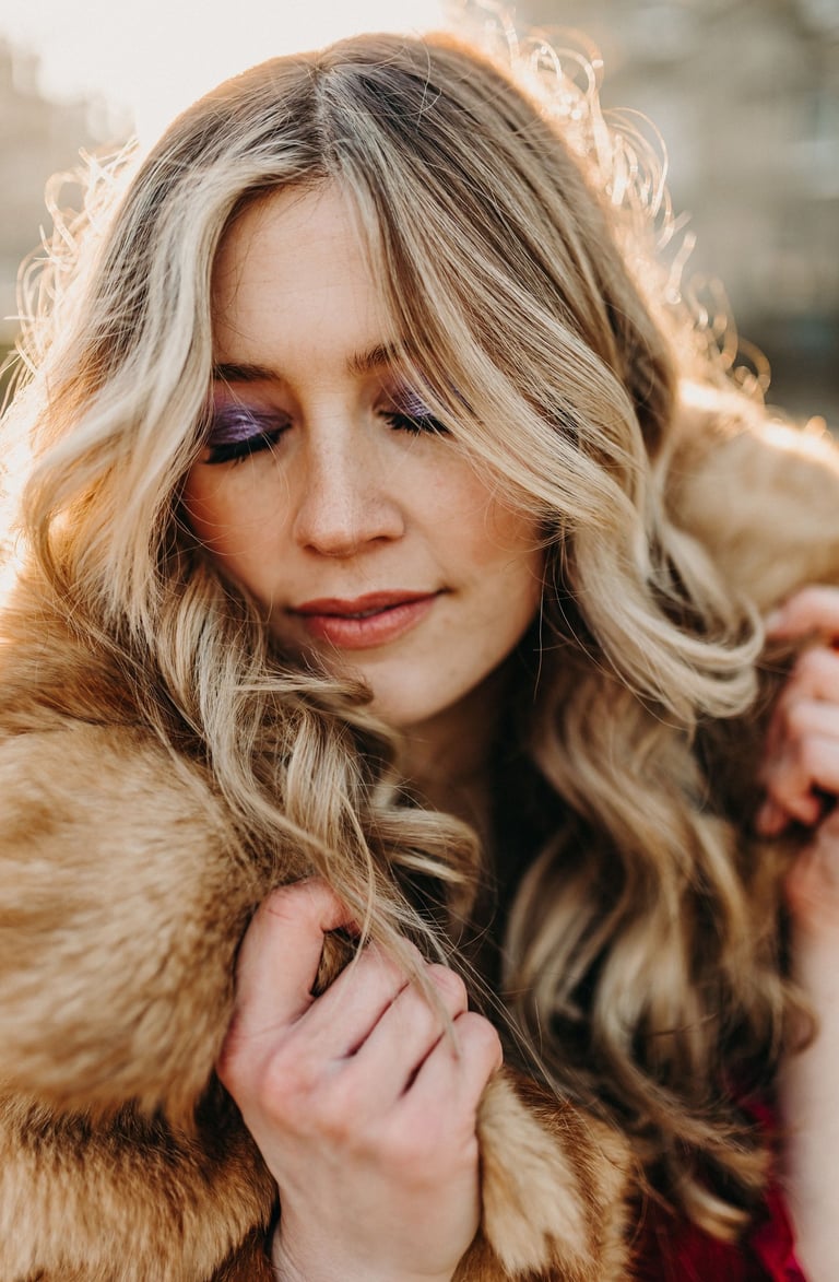 woman with 70s style makeup, and long blonde curled hair