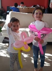 Birthday Girl Holding Balloon Animal Made by Doodad the Funny Las Vegas Kids Magician
