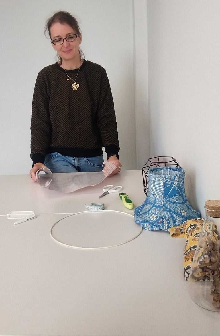 a woman sitting at a table with a paper bag