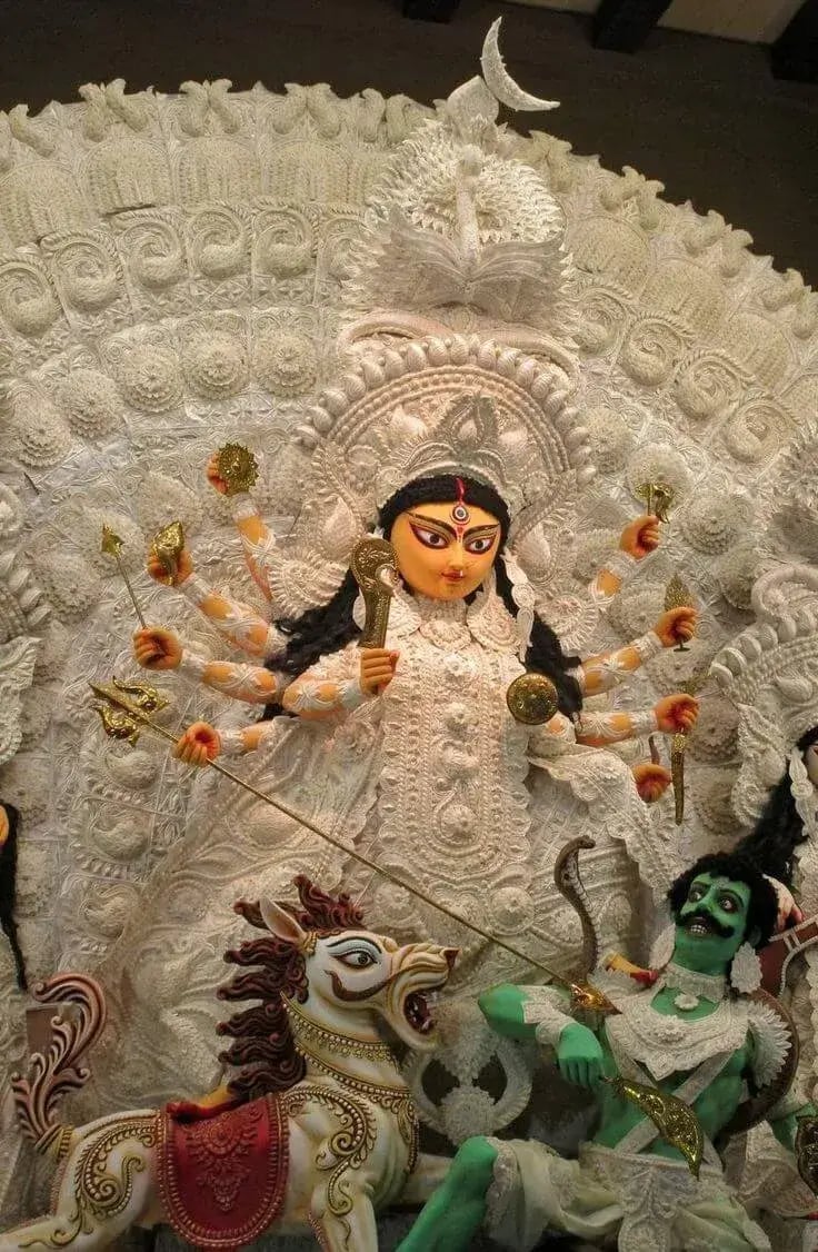 a statue of a Maa durga with a large headdress