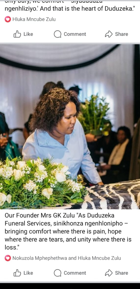 Duduzeka Funeral Services founder Mrs GK Zulu standing by white floral funeral arrangements.