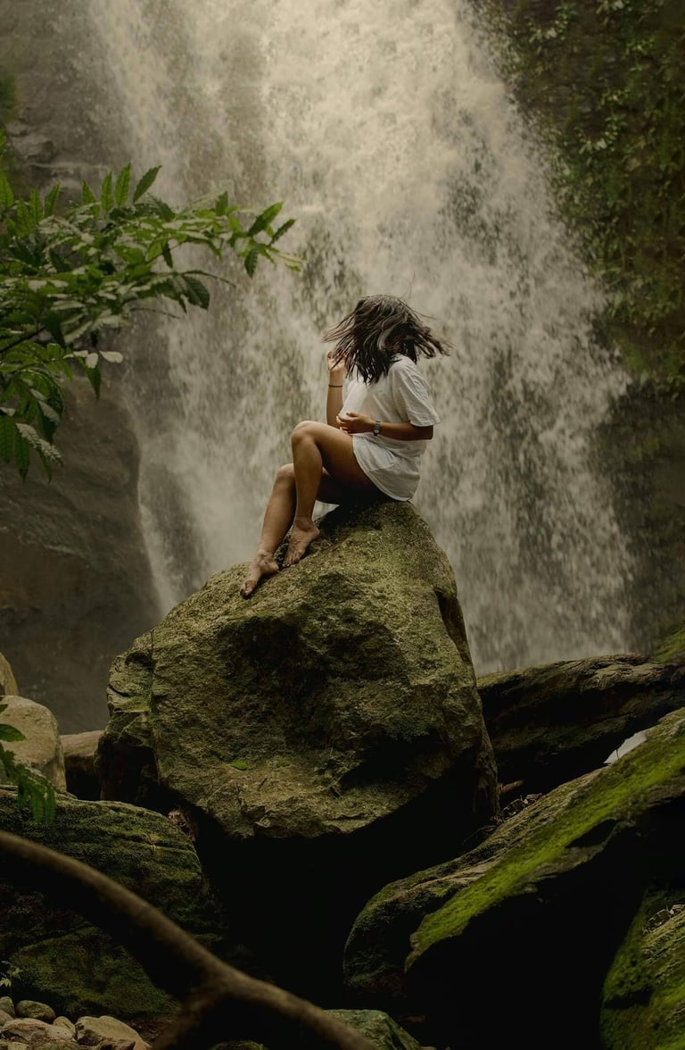 a waterfall in a canyon with a waterfall in the background