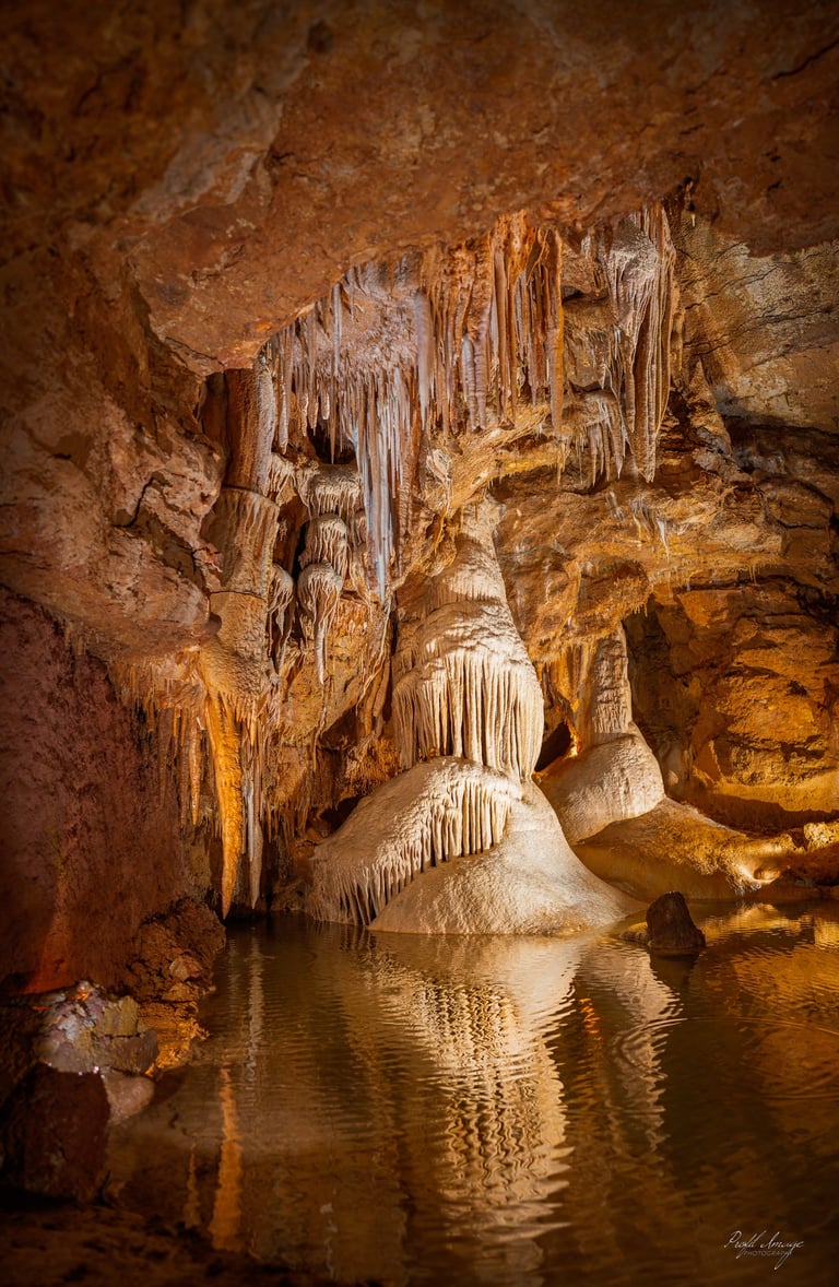 a cave with a waterfall and a waterfall