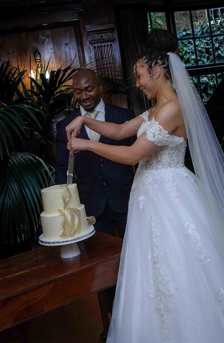 newly-weds cutting their cake
