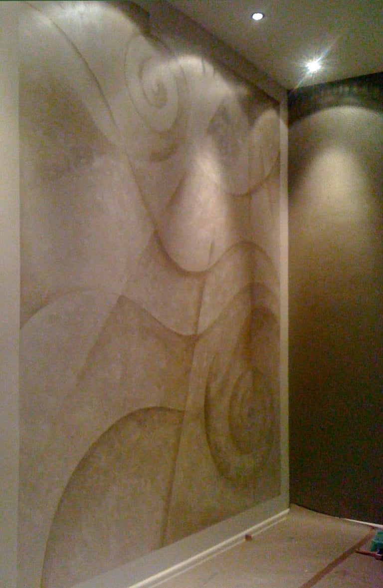 A room with abstract mural in silver paint featuring lines and wavy curves.