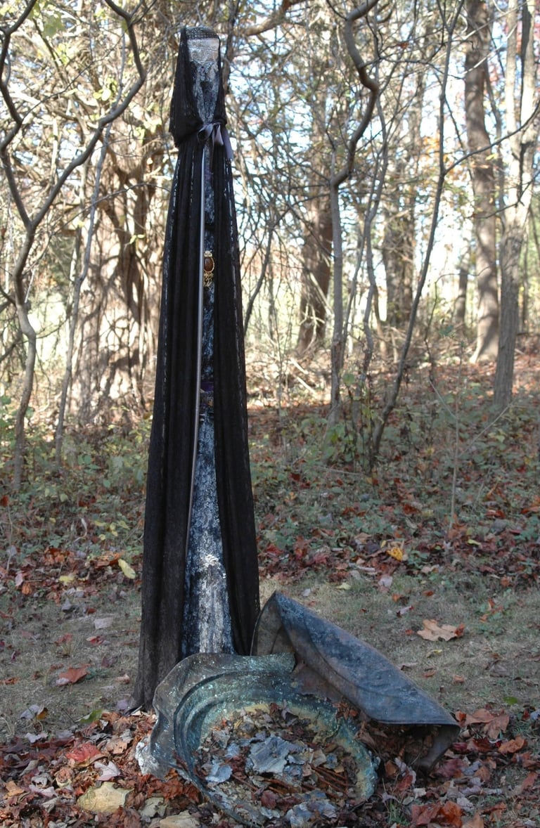 Pole draped in black fabric standing in the woods