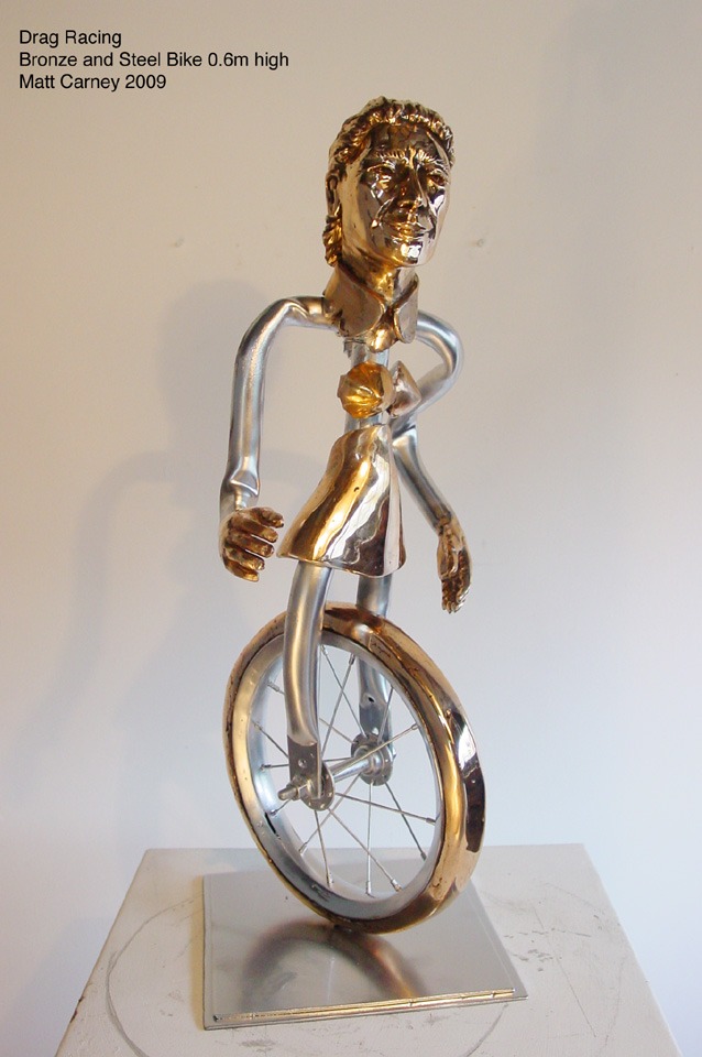 a statue of a man as a bicycle