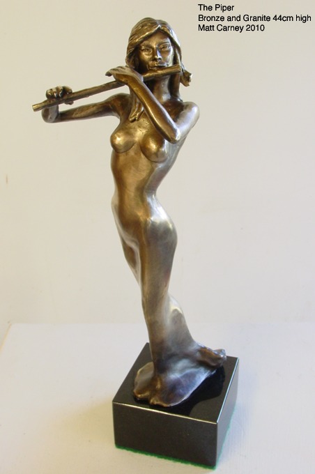 a statue of a woman playing a flute