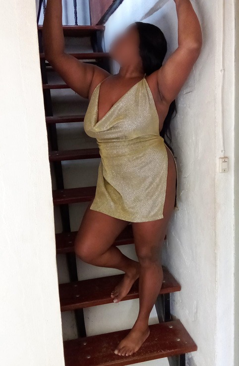 a woman in a short dress is standing on a stair case