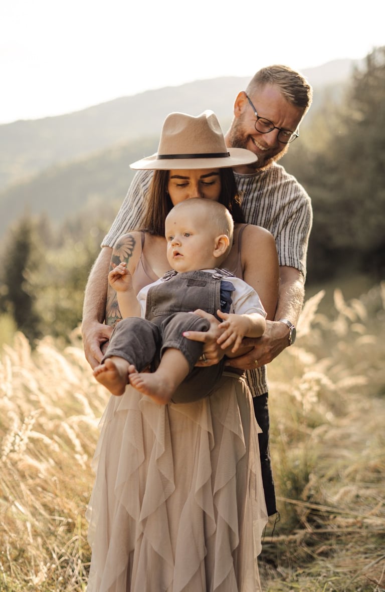 Mother and father holding their baby during an outdoor family photoshoot in the South Downs 