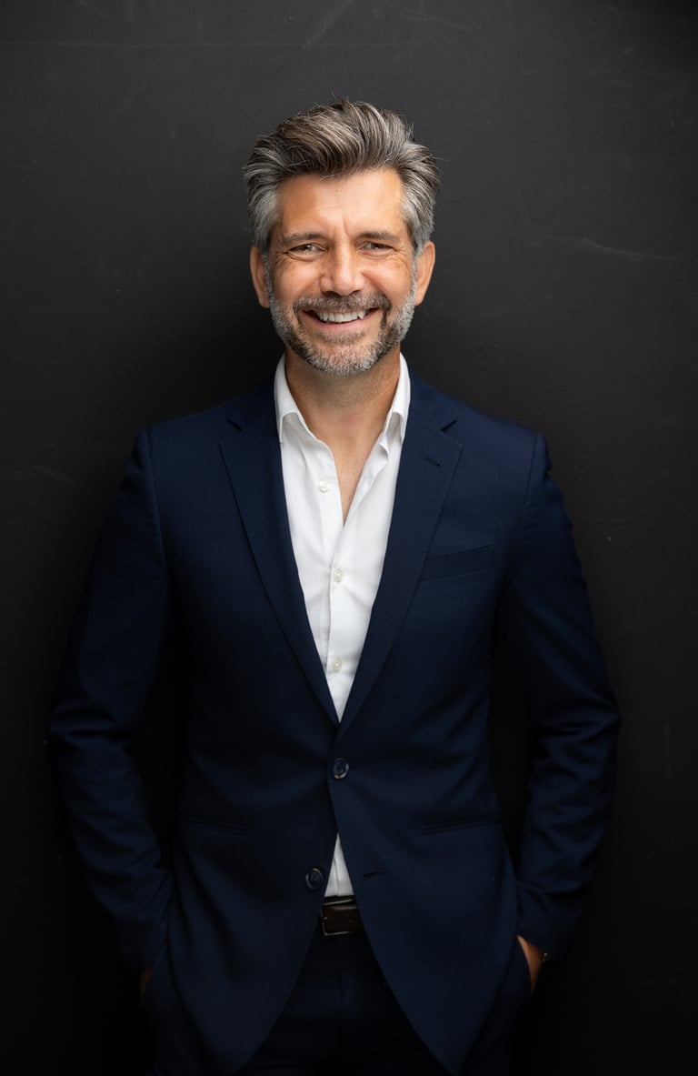 Akin Karaca, a Fractional CFO in a suit and a white shirt