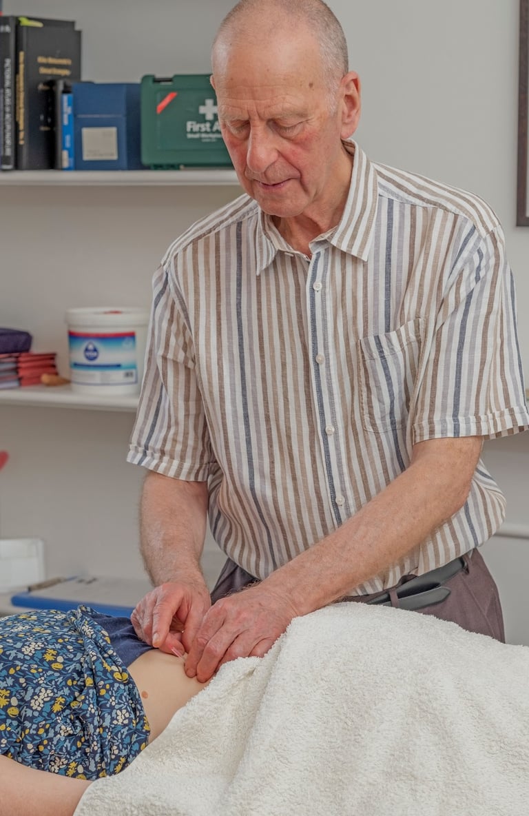 acupuncturist giving treatment to a patient