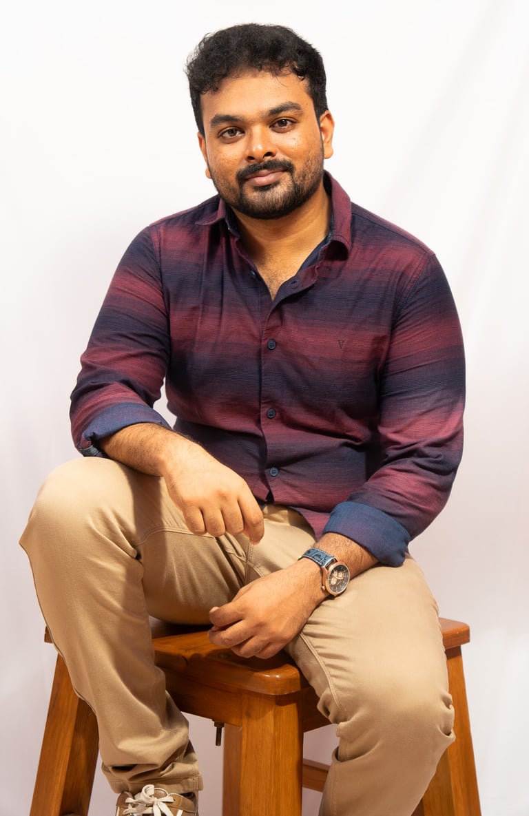 a man sitting on a stool with his feet on a stool