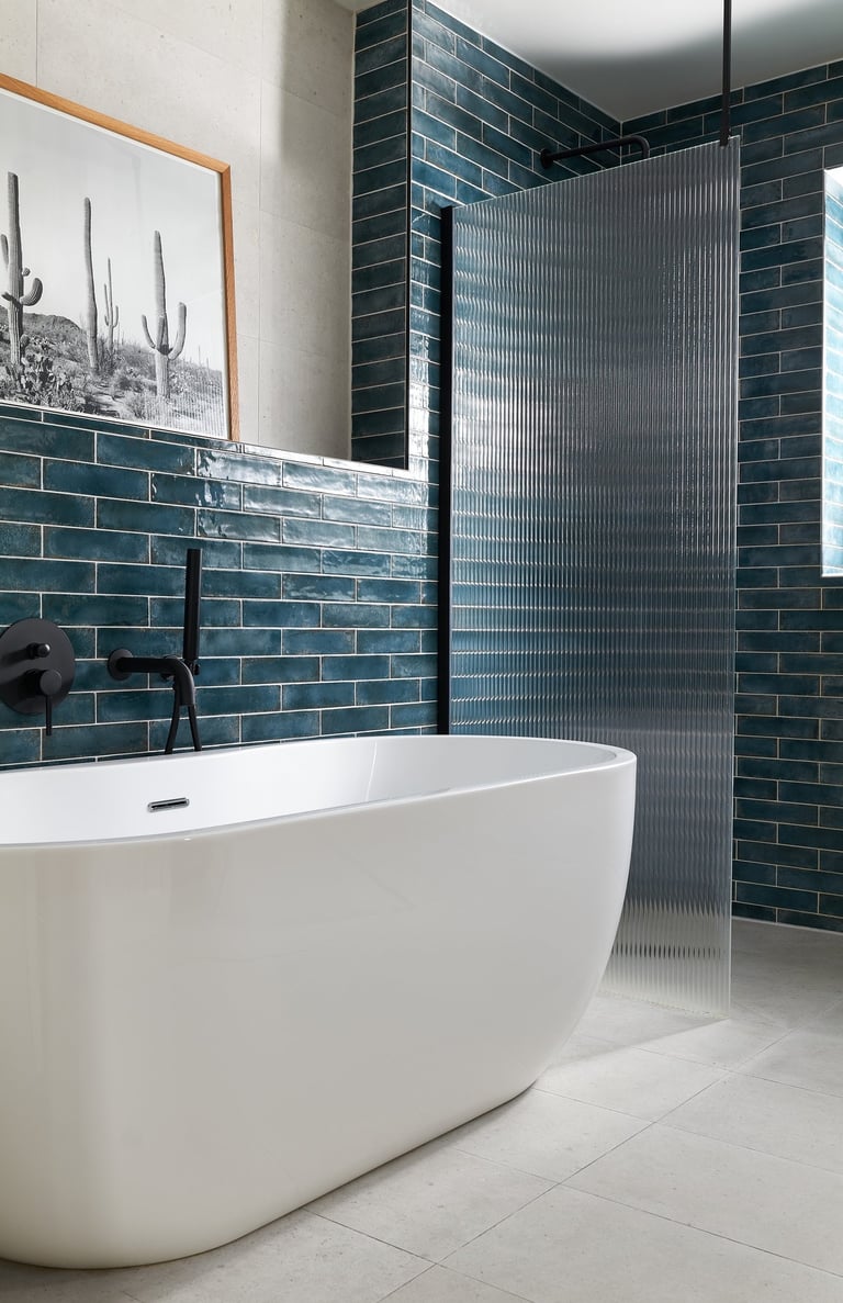 deep, glossy teal metro tiles, laid in a horizontal stack with white grout and fluted shower screen
