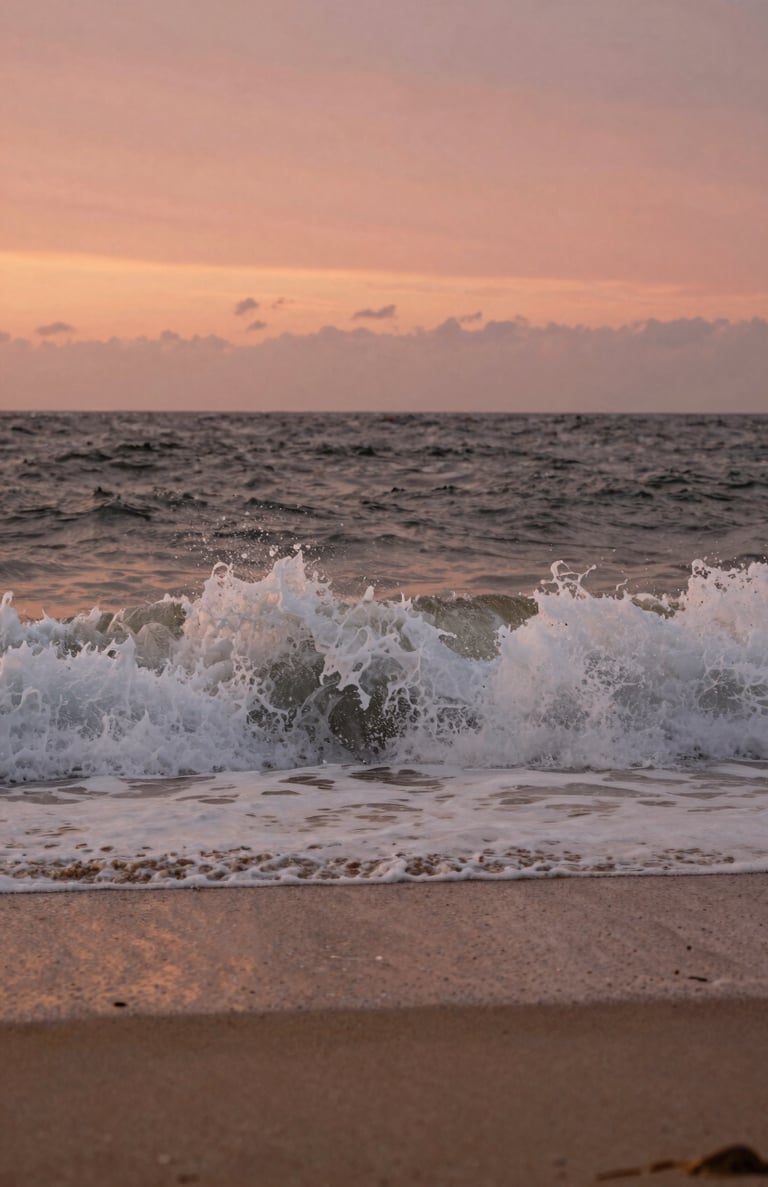 Detail shot of waves crashing on a North American / US beach at sunset. Warm terracotta and soft sand colors in the water and sky. Cinematic and serene.