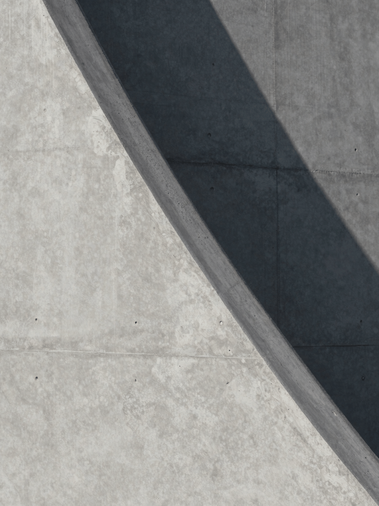Close-up of architectural textures featuring smooth concrete and sharp shadows. Minimalist and sophisticated composition in gray tones. International / Professional.