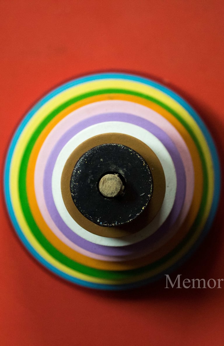 a colorful striped vase with a black and white background